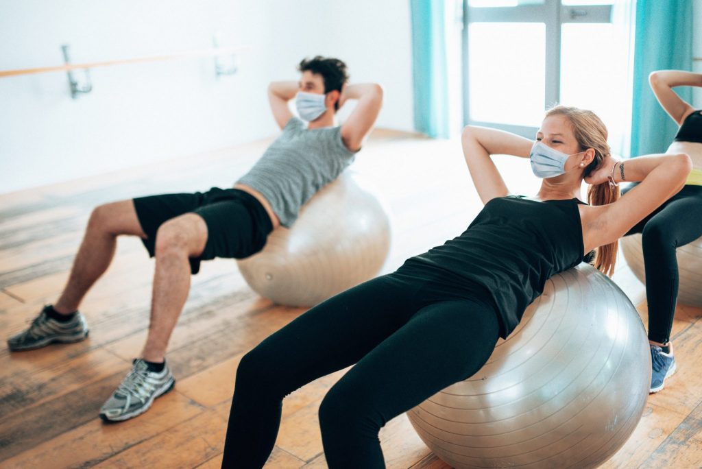 two people exercise the pandemic wearing masks