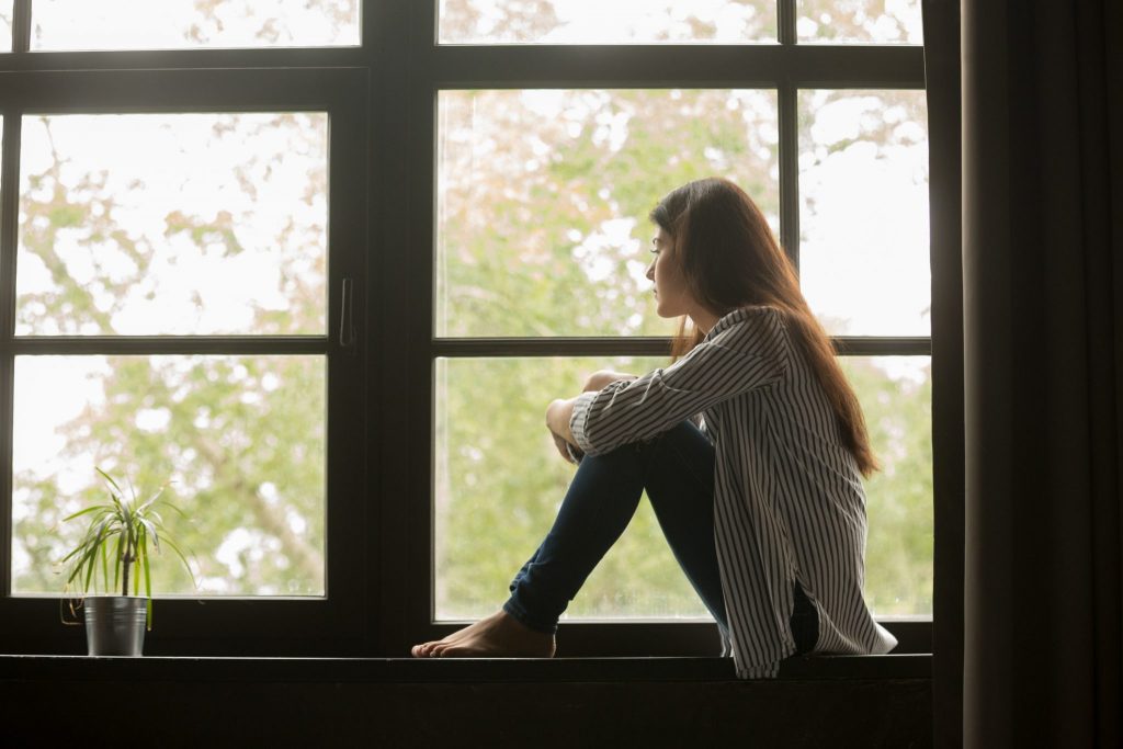 girl sitting and looking out of window